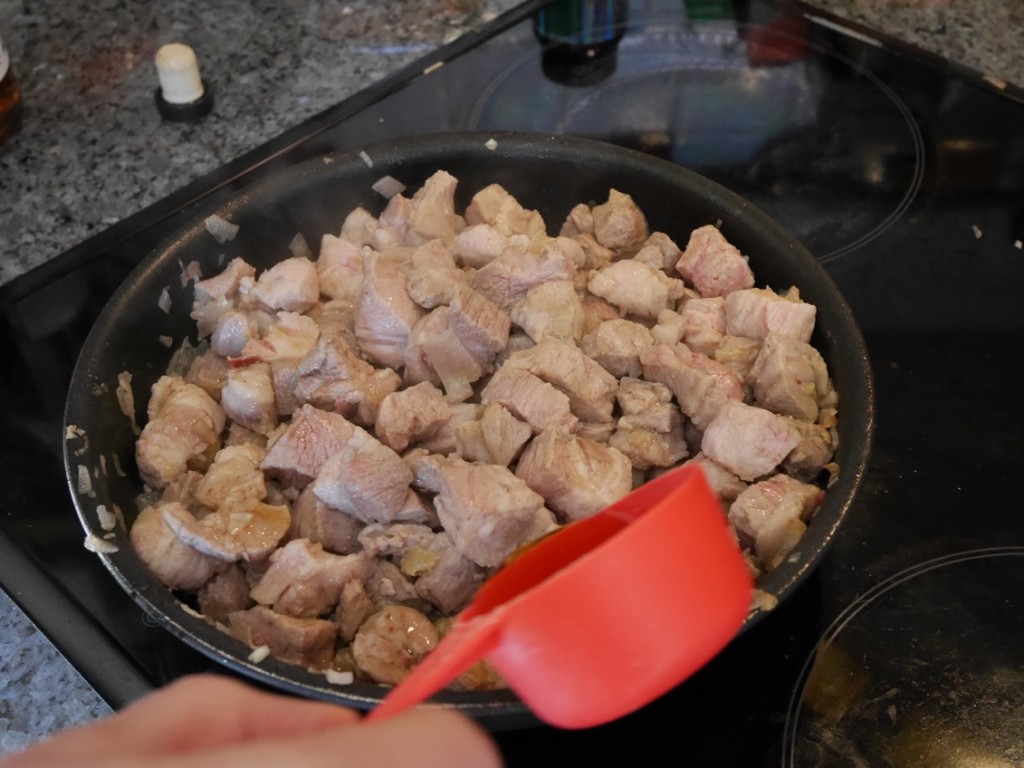 Bacon, schalottenlök och fläskkarré bryns i panna och konjak hälls ned.